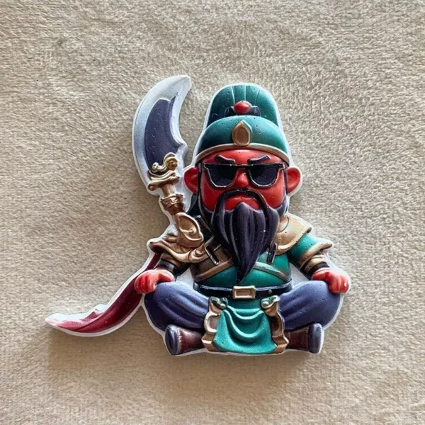 Front view of a Guan Gong fridge magnet seated cross-legged, wearing black sunglasses, green armor and a long black beard.