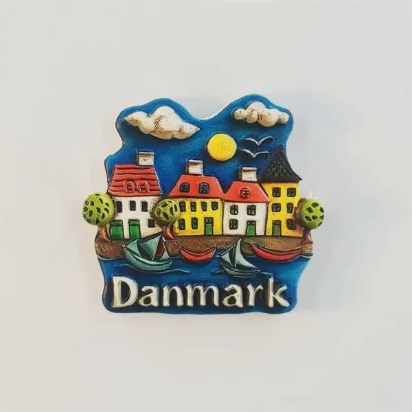 Denmark harbour houses fridge magnet with white and yellow buildings, sailboats, a yellow sun and raised Danmark lettering.