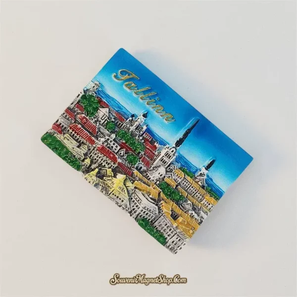 Tallinn Old Town skyline fridge magnet tilted clockwise, showing raised buildings, dark spires and gold Tallinn lettering.