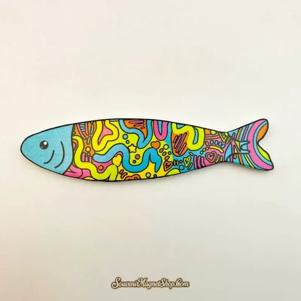 Graffiti Fish fridge magnet with a turquoise face and bright yellow, pink and blue doodles outlined in black.