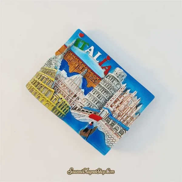 Italy landmarks fridge magnet tilted clockwise, showing raised architecture and tricolor ITALIA lettering on a blue background.