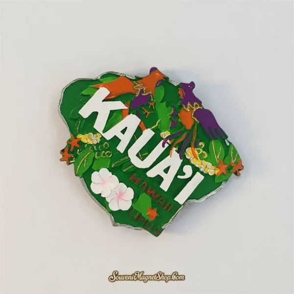 Kauai birds and flowers fridge magnet tilted clockwise, showing white lettering and the silvery irregular edge