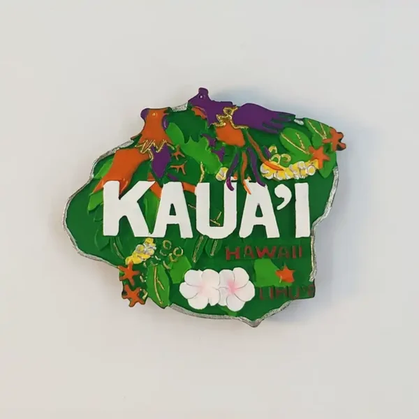 Kauai fridge magnet with white KAUA’I lettering, orange and purple birds, green foliage and pale flowers, front view