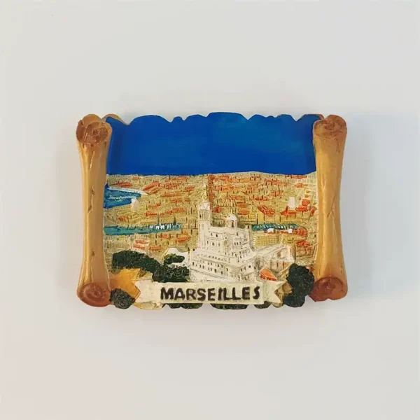 Marseille Old Port fridge magnet with a golden scroll frame, raised Notre-Dame de la Garde, blue harbour and MARSEILLES banner.