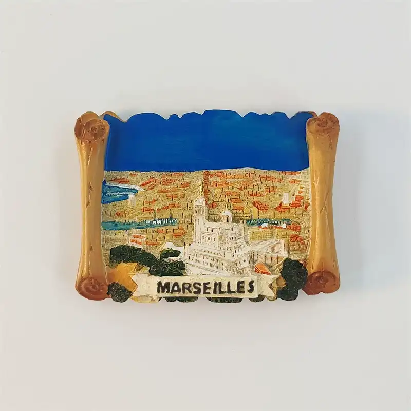 Marseille Old Port fridge magnet with a golden scroll frame, raised Notre-Dame de la Garde, blue harbour and MARSEILLES banner.