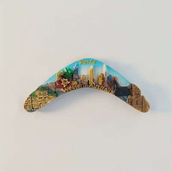 Perth boomerang-shaped fridge magnet with a raised skyline, blue sky, floral motif and gold-tone Western Australia lettering.