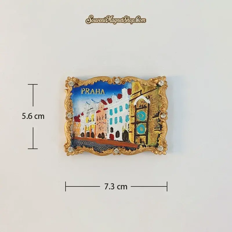 Prague Old Street A variant fridge magnet with pastel façades and two turquoise clock dials on the right, framed by a gold-tone border.