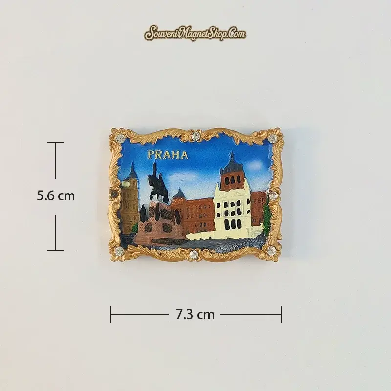 Wenceslas Square B variant fridge magnet with an equestrian statue, pale tower and red-brown buildings inside an ornate gold-tone border.